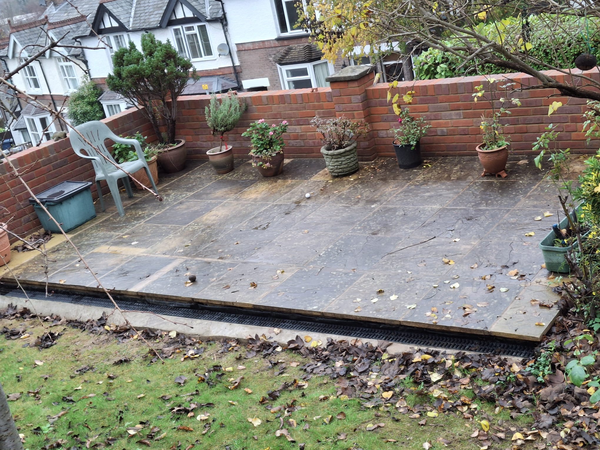 Brick garden wall with slate patio