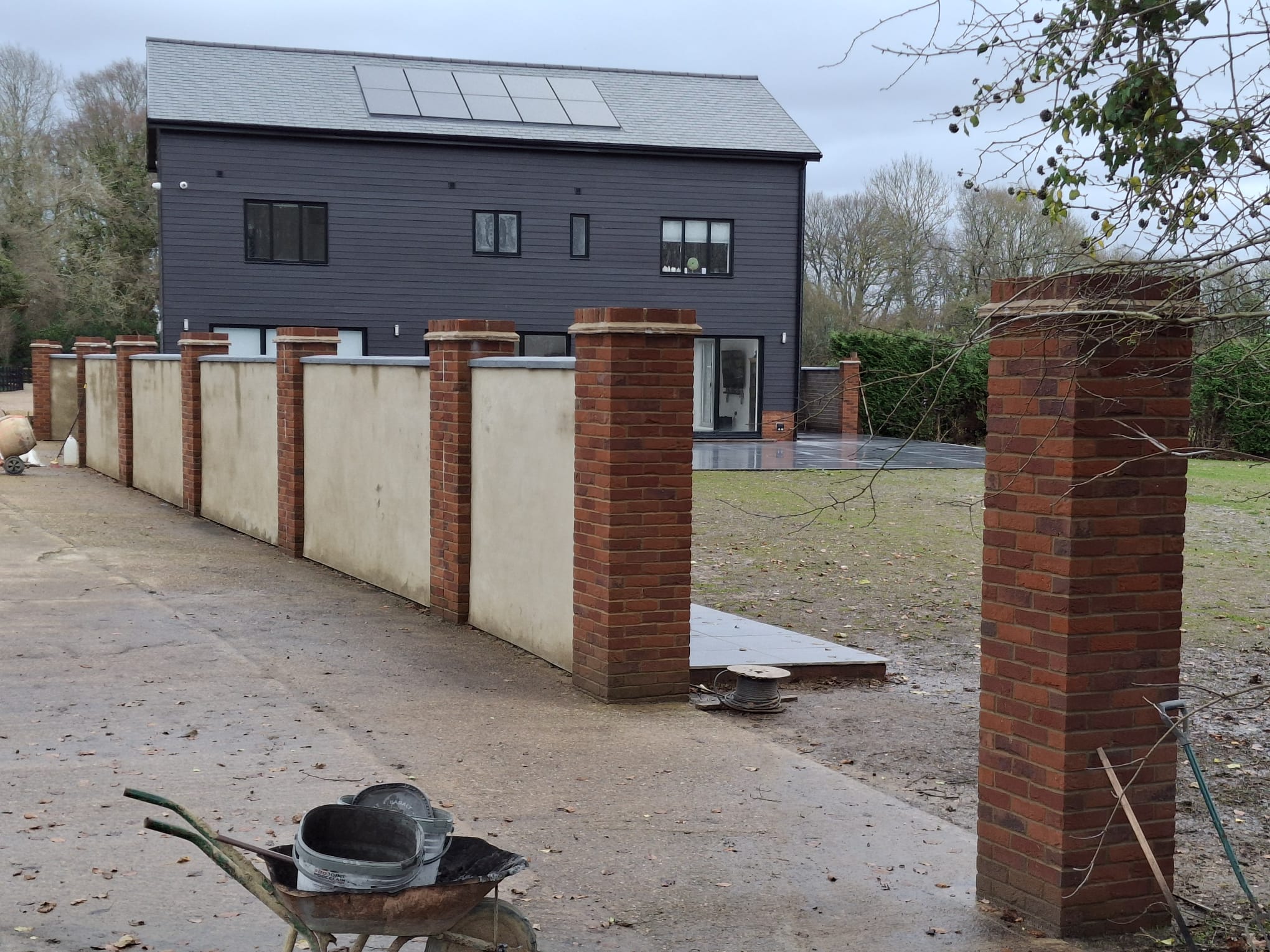 New build brickwork — brick pillars and render wall