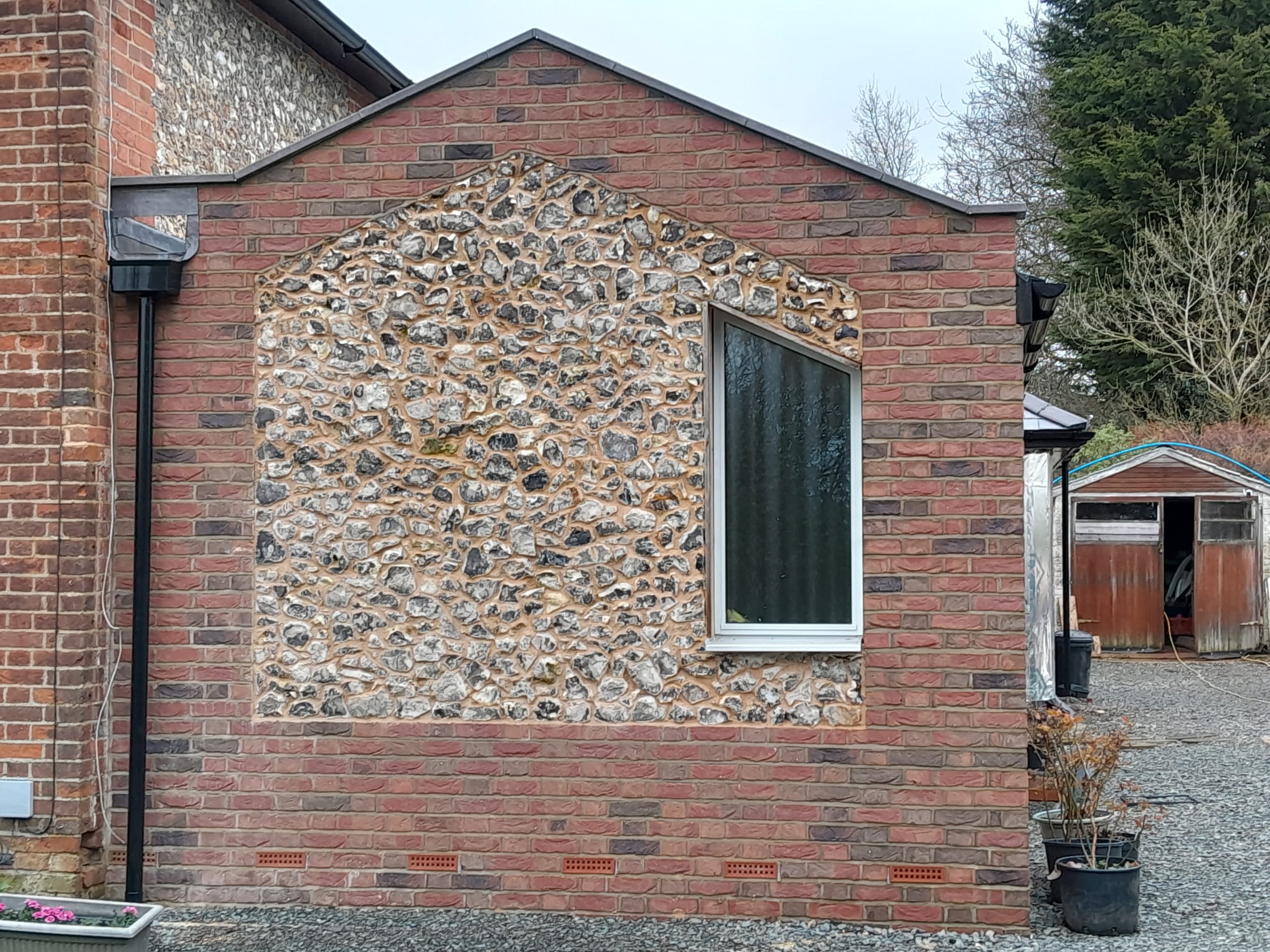 Flint and brick extension on period property