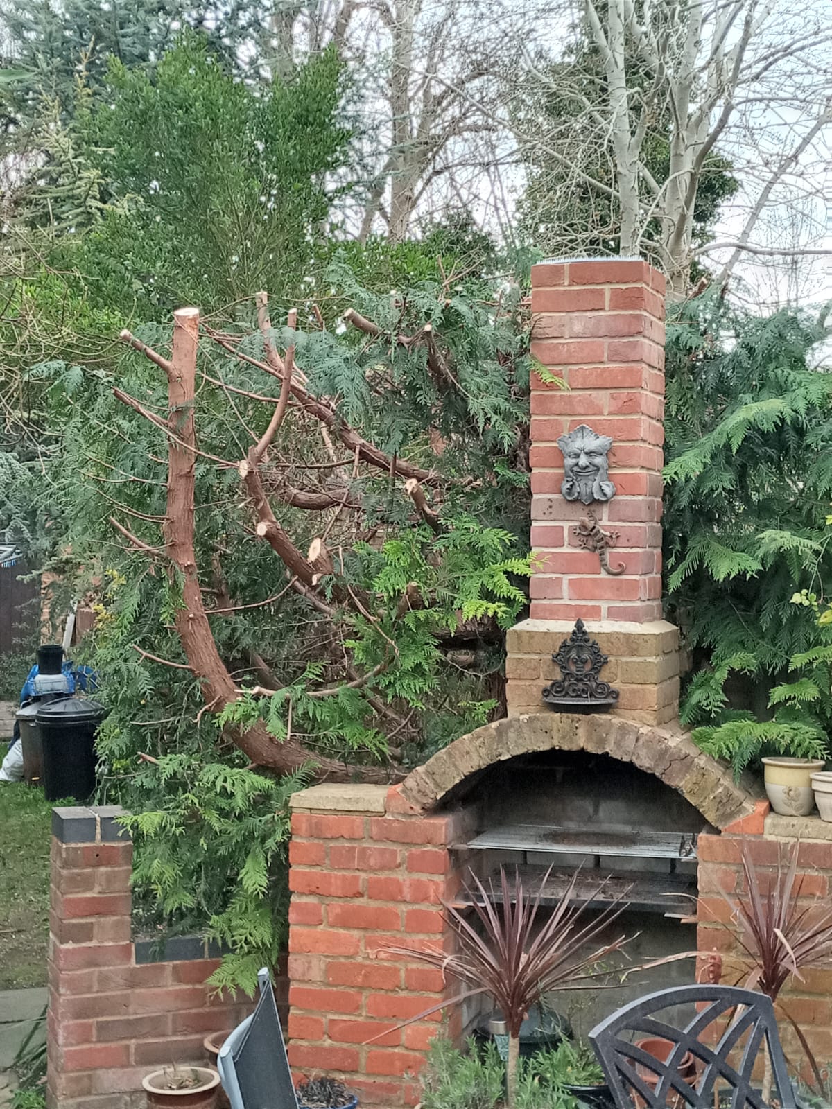 Brick outdoor fireplace with decorative arch