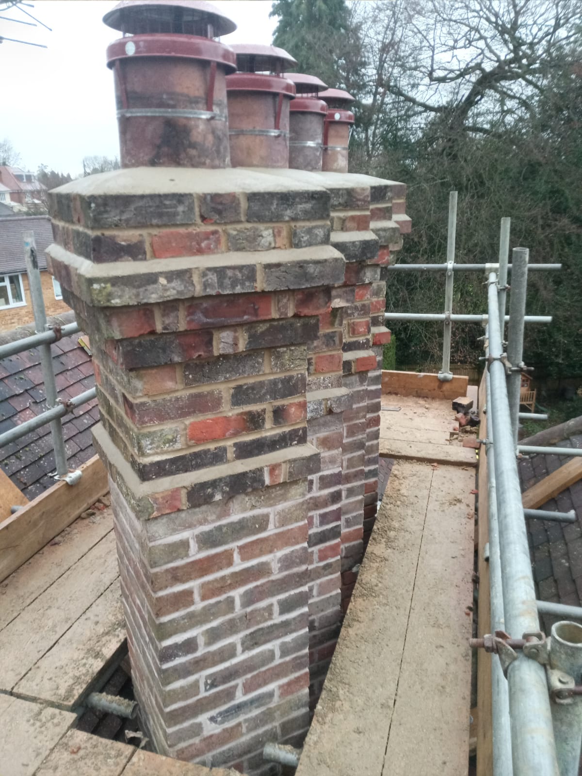 Large Victorian chimney being restored on scaffold