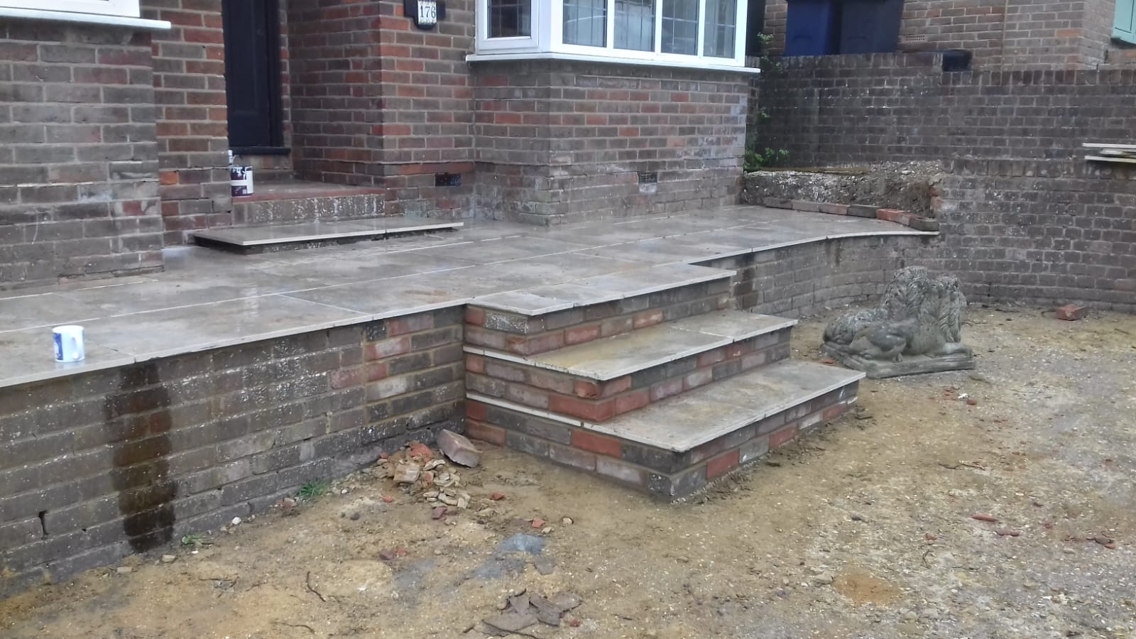 Brick retaining wall with stone paving steps